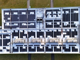 Aerial View of Rooftop Solar Panel Installation on Industrial Building
