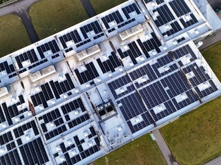 Aerial View of Rooftop Solar Panel Installation on Industrial Building