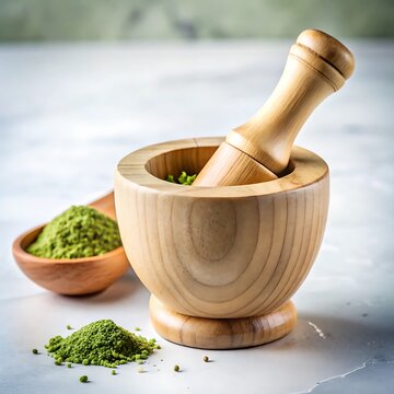 Wooden mortar and pestle with green powder and spoon