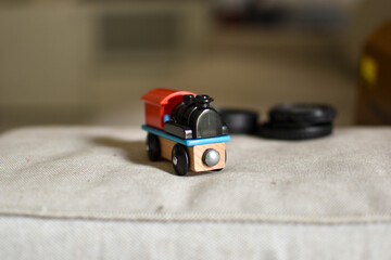 Fototapeta premium Toy train with red top, black wheels, and blue