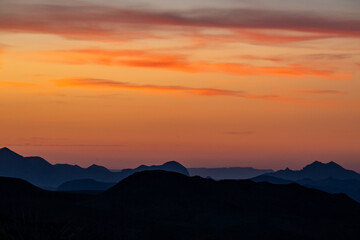 Fototapeta premium Orange Sky Blankets The Silhouetted Ridges Of Big Bend