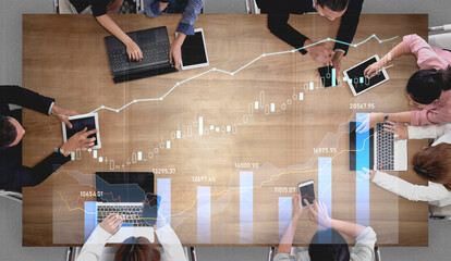 A diverse business team engaged in collaboration, analyzing digital data trends and strategies together. Modern workspace emphasizes teamwork and innovation. Scalp