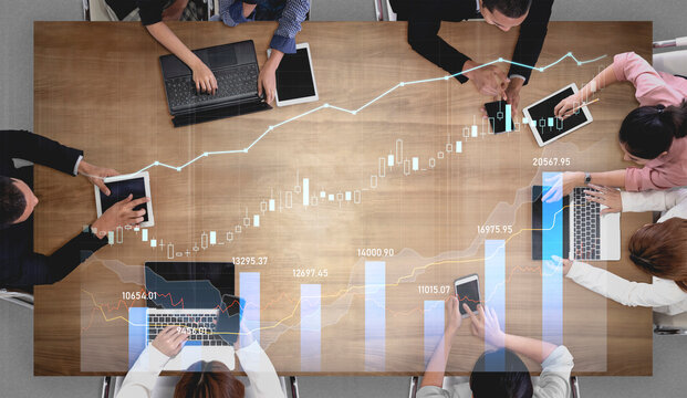 A diverse business team engaged in collaboration, analyzing digital data trends and strategies together. Modern workspace emphasizes teamwork and innovation. Scalp - Powered by Adobe