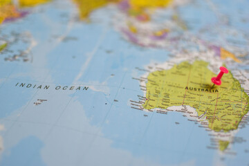 World map close-up with red pushpin marking eastern Australia, showing surrounding regions including Southeast Asia and the Pacific Ocean.