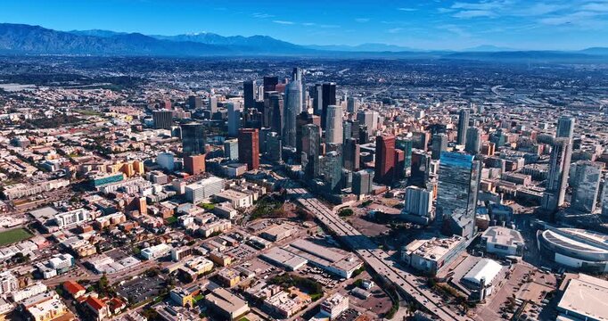Low-rise cityscape around high-rise group of buildings. Approaching the stunning midtown of Los Angeles, California, USA on sunny day.