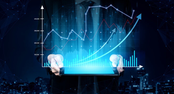 A business professional stands in a dark cityscape, holding a tablet displaying vibrant digital graphs and charts that highlight financial growth and data trends. Scalp - Powered by Adobe