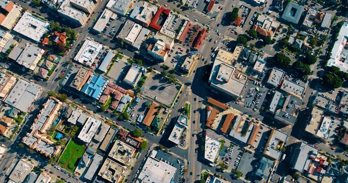 Footage over the street of the lively city on sunny day. Top view on the cityscape of modern Los Angeles, California, USA.