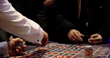 Gambling Game Scene, Individuals Strategically Placing Chips Around Roulette Table On Lowlit Gambling Floor © Joachim