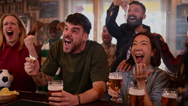 Group of diverse friends celebrating victory in sports bar