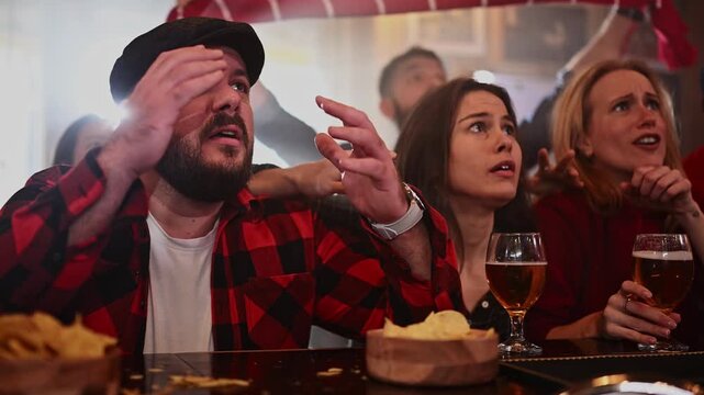 Disappointed sports fans reacting negatively to losing game