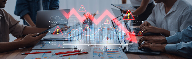 A dynamic office scene featuring a business team analyzing digital data on laptops, with financial...