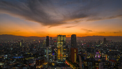 Aerial stunning sunset in Mexico City with views of Paseo de la Reforma and the skyline.