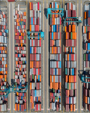 Aerial top down view over the containers of a maritime port. Shipping containers