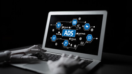 A laptop screen showcases vibrant advertising concepts while a robotic hand engages with the interface, symbolizing innovation in digital marketing. Tessel