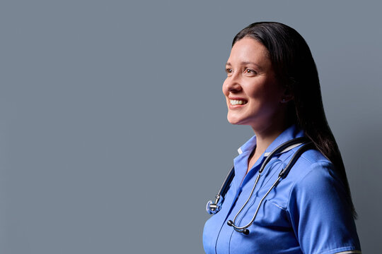 Profile portrait of middle-aged woman doctor, nurse on grey studio background