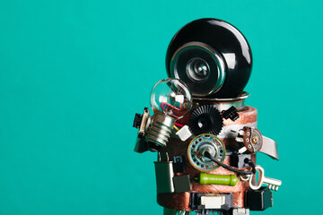 Creative idea concept. Robot looking at light bulb. retro style toy character with funny black...