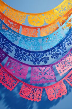 Vibrant papel picado decorations on blue background for mexican fiesta celebrations