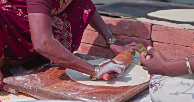 Indian Village Women And Men Preparing Mahaprasad Roti for a Spiritual Mass Gathering