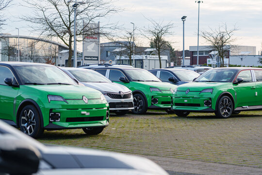 Green new Renault 5 electric cars parked at a dealership lot in Dusseldorf