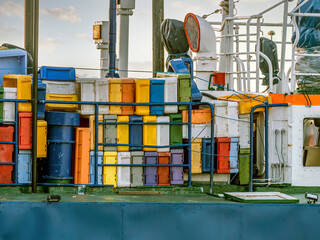 Fishing boat loaded with colorful fish boxes