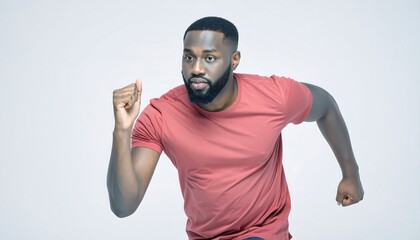 Handsome African man in a red t-shirt running with determination on a white studio background.
