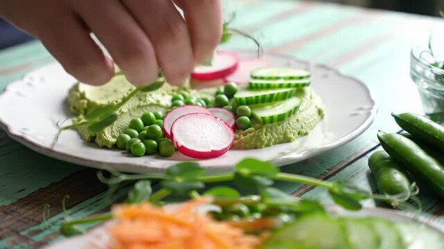 Exquisite healthy plant-based spring cuisine on rustic blue-green wooden table; dolly video & macro close-ups reveal textures, hand garnishes, soft daylight. Concept of mindful eating and vitality