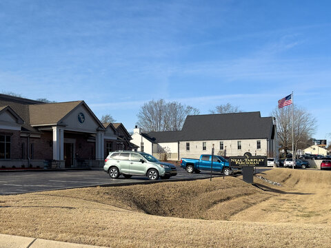 Neal-Tarpley-Parchman (NTP) Funeral Home on Madison Street in Clarksville, TN, with copy space in the slightly cloudy, blue sky