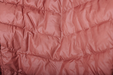 Pink quilted jacket fabric texture with stitched pattern