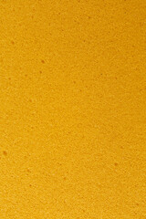 Fototapeta premium Yellow porous foam texture background