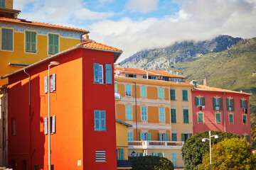 Fototapeta premium Brightly painted traditional residential buildings with colorful shutters in Menton, France