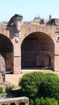 basilica maxentius massive vaulted arches surviving walls towers above roman forum ruins framed by modern rooftops domes rome italy of ancient architecture historic landmark 
