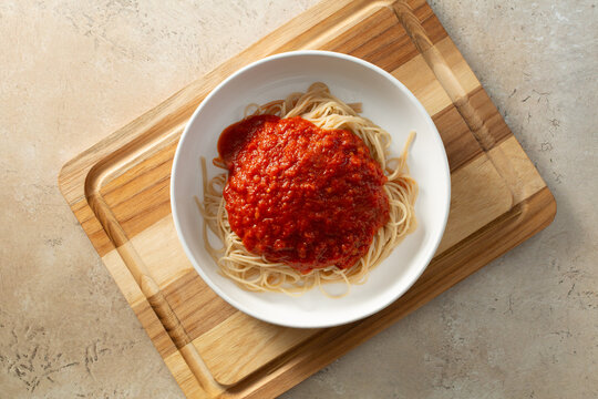 A top down view of a bowl of gluten-free capellini marinara.
