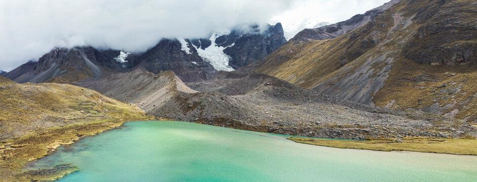 Aerial Drone View hike the seven 7 lakes of Ausangate cusco, Peru clouddy day green water mountains.