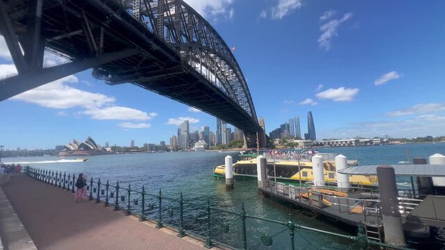 Passengers embarking a Ferry under Sydney Harbour Bridge. Sydney Harbour ferry services date back to the first years of Sydney's European settlement.
