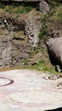 roman archaeological trench displays massive fallen stone column beside geometric marble floor fragment rubble metal supports appear tempio del divo romolo close view rome italy empire 