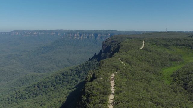 Drone downward flying aerial footage of Kedumba Valley Road located in a large forest in Jamison Valley in the Blue Mountains in New South Wales, Australia.