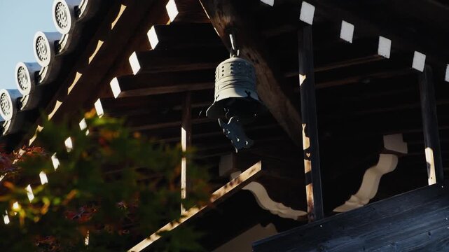 Traditional japanese temple bell hanging from roof