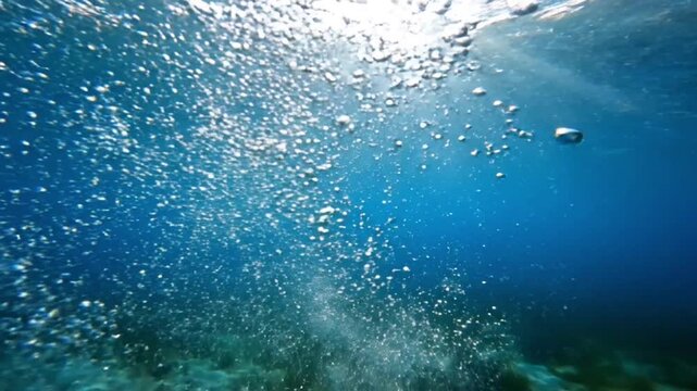 Underwater Bubbles Rising in Deep Blue Ocean Water with Sunlight Rays