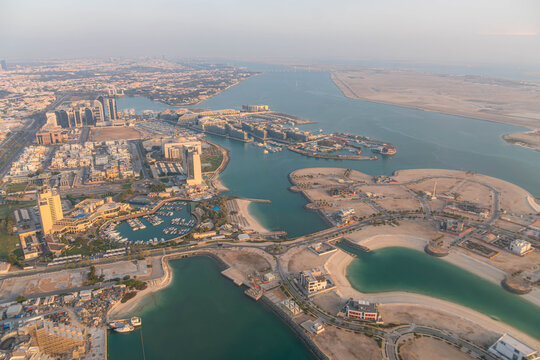 Aerial panoramic view of Abu Dhabi, UAE, revealing modern architecture, yacht marinas, artificial lagoons, sandy beaches, in the oil-rich Middle East.
