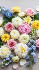 Romantic floral arrangement featuring roses, ranunculus, and delphinium
