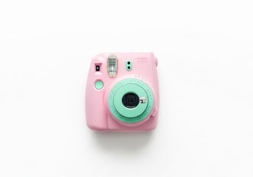 Top view of a pink fujifilm instax mini 9 camera isolated on white background