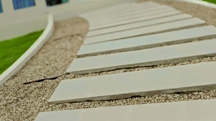 Modern garden walkway with white concrete stepping stones on gravel, minimalist outdoor design with clean lines.