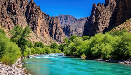 River Flow in Canyon: A captivating landscape, with a vibrant river winding through a towering canyon, the azure water reflecting the clear blue sky.
