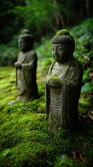 Fototapeta premium Ancient Stone Statues Surrounded by Lush Green Moss in Tranquil Forest Setting