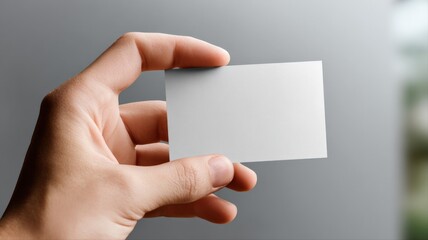 Fototapeta premium Hand Holding Blank Business Card Mockup for Branding Identity and Professional Presentation
