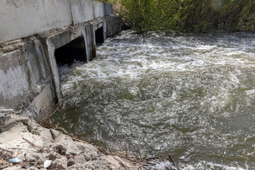 Obraz premium a concrete sluice with large windows for the passage of water 