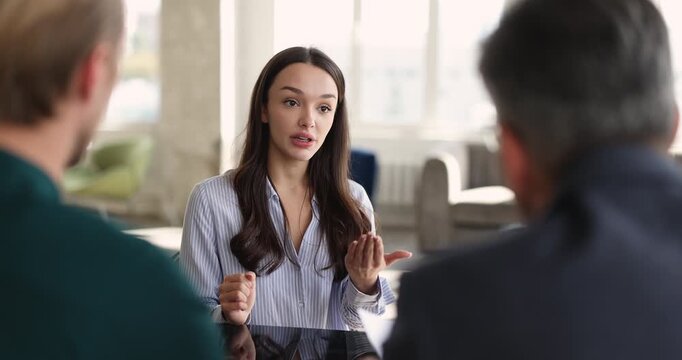 Confident female applicant handshaking with HR managers at end of successful job interview, represents employment, positive communication, hiring approval, start of new career opportunity in company