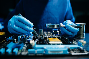Closeup of expert soldering a green PCB board using precision tools. Ideal for electronics, circuit repair, engineering, tech © Nuttapong punna
