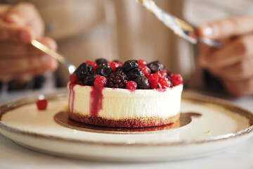 Enjoying dessert with mixed berries on top of cheesecake © Towfiqu Barbhuiya 