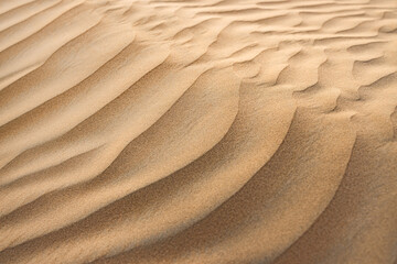 Artistic gold sand texture in abstract summer desert landscape, seasonal nature background, peaceful serene wallpaper, ideal for wall art, banners, and decorative design © icemanphotos
